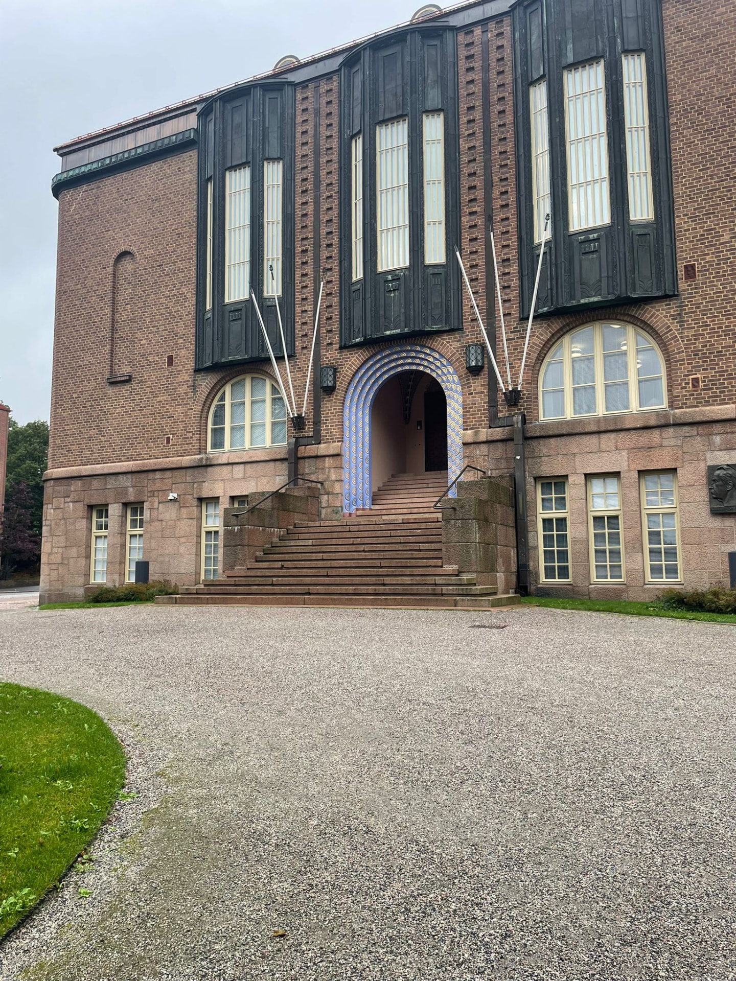 Entrance of Lahti City Hall with its decorated blue-tiled archway and granite steps